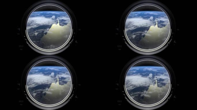 通过国际空间站舷窗的地球。车站围绕地球运行。现实的氛围。3D体积云。空间。国际空间站。4K。