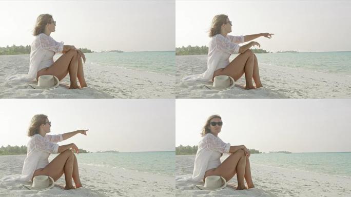 来自马尔代夫阳光海滩的肖像画女士在海洋中说话和指着海洋