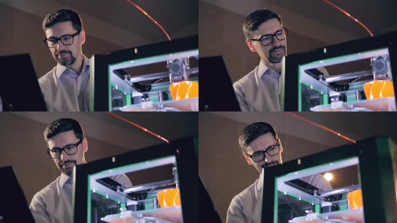 一位拥有笔记本电脑的工程师正在观看3d打印机的工作