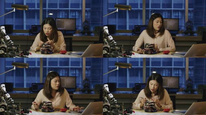 年轻的亚洲女性电子开发工程师与机器人一起工作，在车间的机器人原型电路中测量信号。有技术或创新概念的人
