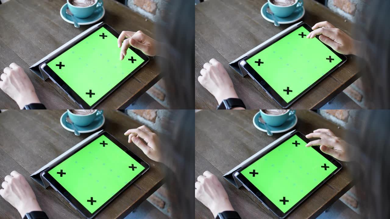女人在咖啡馆使用数字平板电脑绿屏