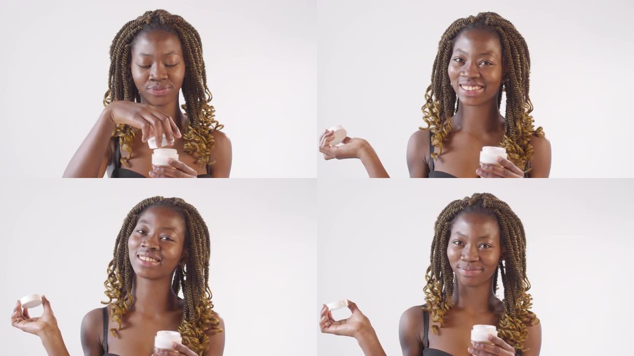 美丽的黑人妇女打开奶油罐