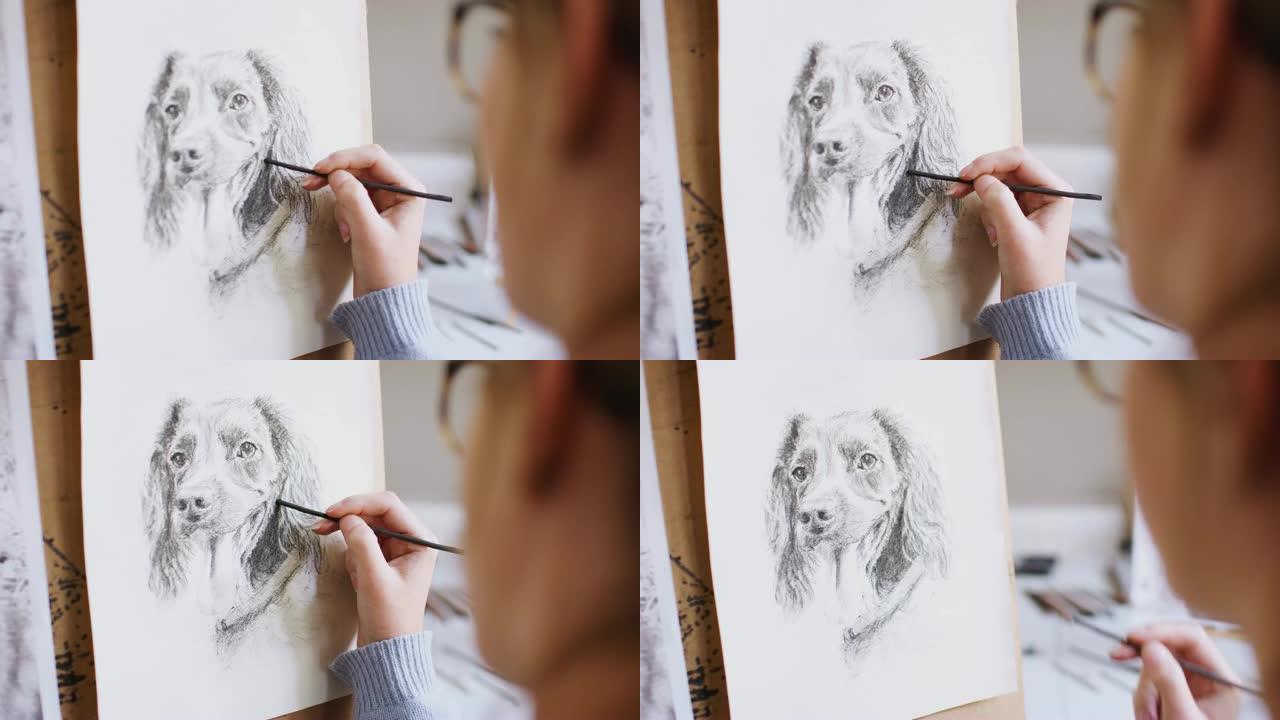 女少年艺术家坐在画架上，用木炭拍摄的狗的照片