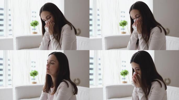 不健康的年轻女子有过敏性鼻炎在家吹鼻子