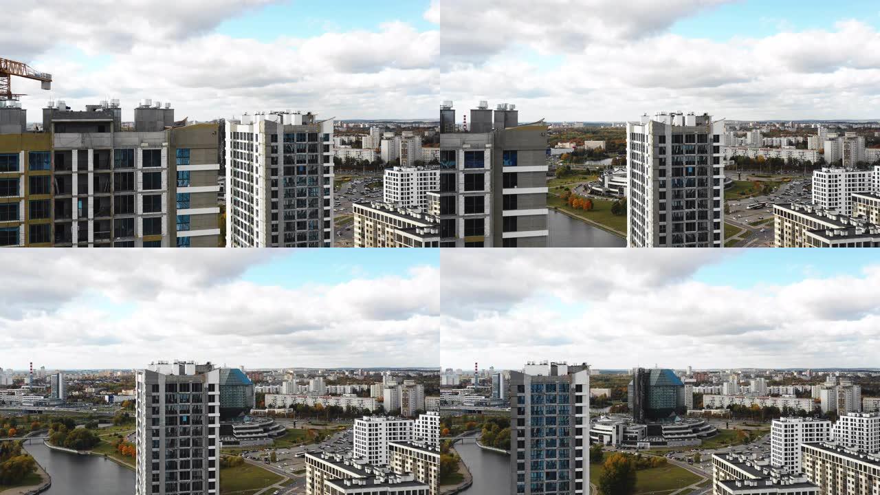 无人机沿着在建的高层城市塔楼公寓楼飞向明斯克白俄罗斯国家图书馆。