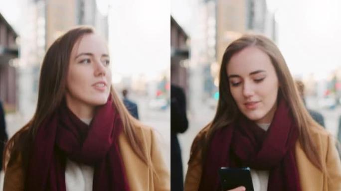 穿着棕色外套的美丽女商人正在市中心的街道上使用智能手机。她走在拥挤的步行街上，看起来很成功。垂直屏幕