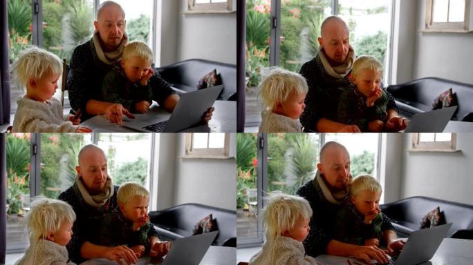 父亲和孩子在家中使用笔记本电脑4k