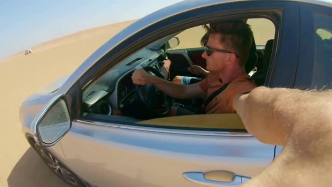 POV男子开车穿越沙漠时自拍