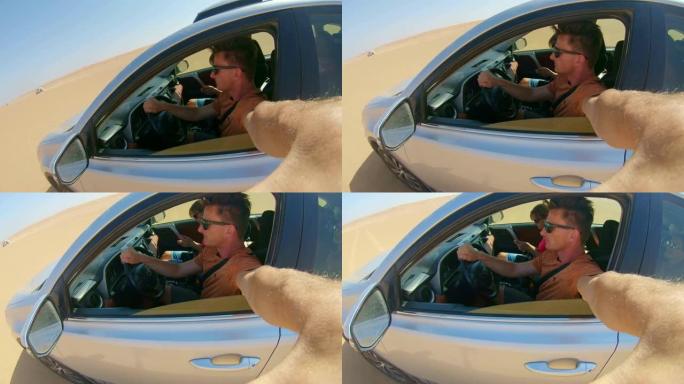 POV男子开车穿越沙漠时自拍
