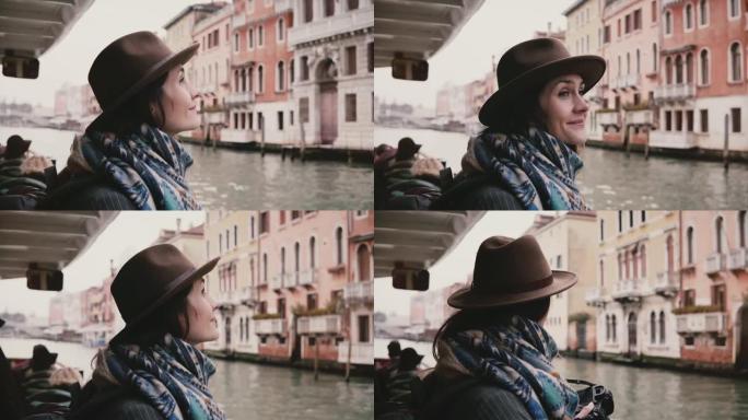 美丽兴奋的高加索旅游女孩微笑着，享受秋天威尼斯惊人的大气缆车游览。
