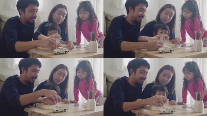 亚洲家庭玩得开心在家玩木头玩具