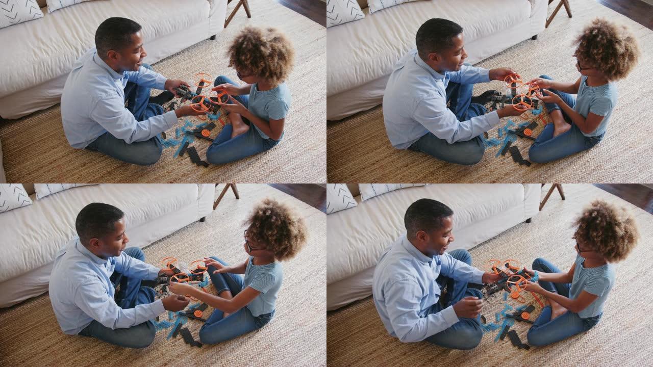 青春期前的黑人女孩和爷爷盘腿坐在地板上建造玩具，高景