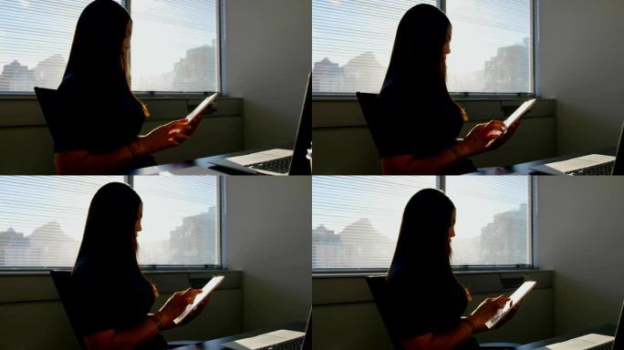 年轻的白人女商人在现代办公室4k上使用数字平板电脑的侧视图