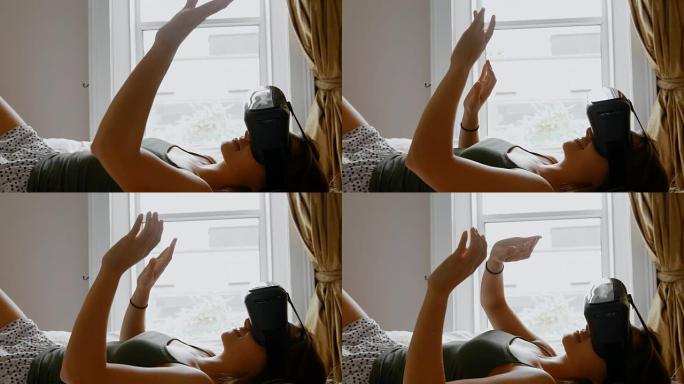 在卧室4k床上使用虚拟现实耳机的女人