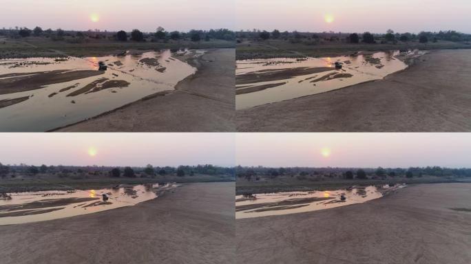 津巴布韦戈纳雷州国家公园日落时一辆4x4车辆穿越润德河的4k视图