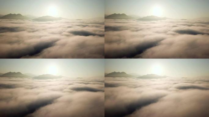空中拍摄云层上的日出时间进入天空上的薄雾向下移动
