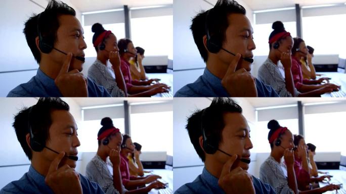 现代办公室4k中，多民族客户销售主管在耳机上交谈