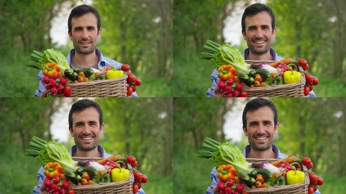 一个快乐的年轻农民在篮子里拿着新鲜蔬菜的肖像。在自然的背景下。
