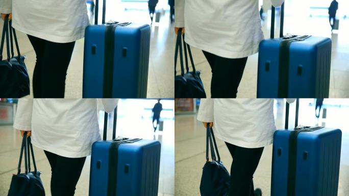 带行李的旅行者在机场散步