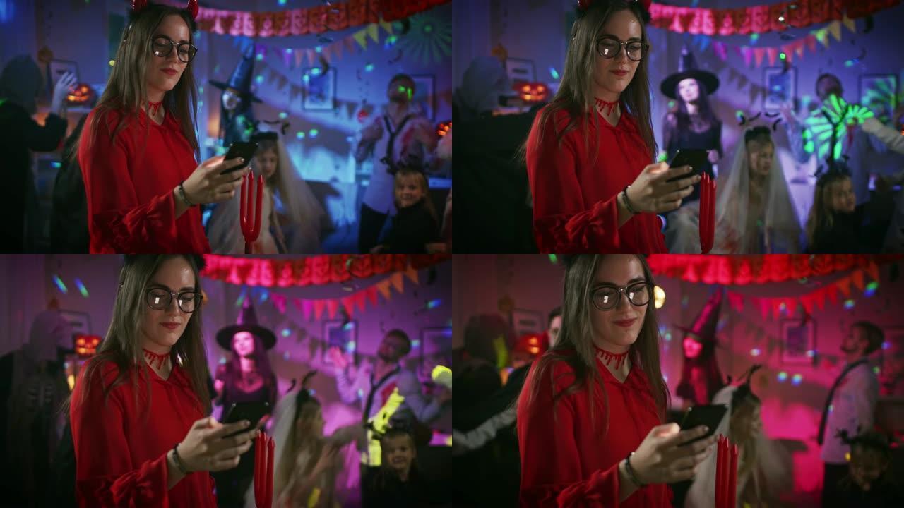万圣节服装派对: 诱人的她与三叉戟使用智能手机。在怪物玩得开心的背景组中，在迪斯科舞会下跳舞。