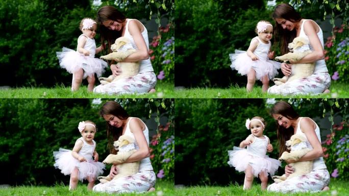 在一个阳光明媚的春天，一个打扮成芭蕾舞演员的小女孩在花园里和她的妈妈和金毛猎犬小狗玩耍，每个人都像一