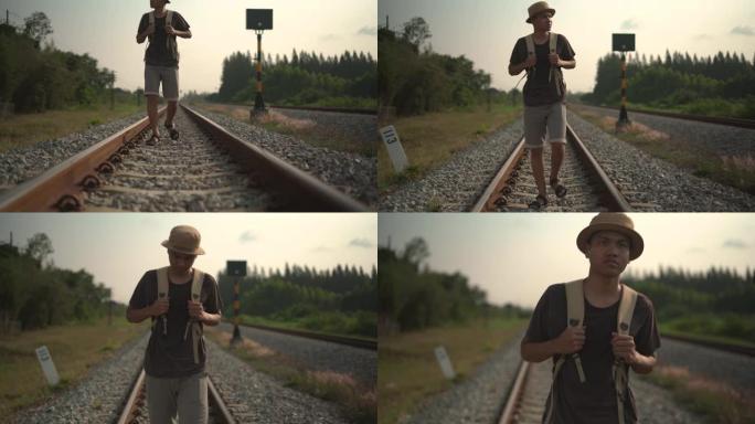 一个年轻人走在铁轨上