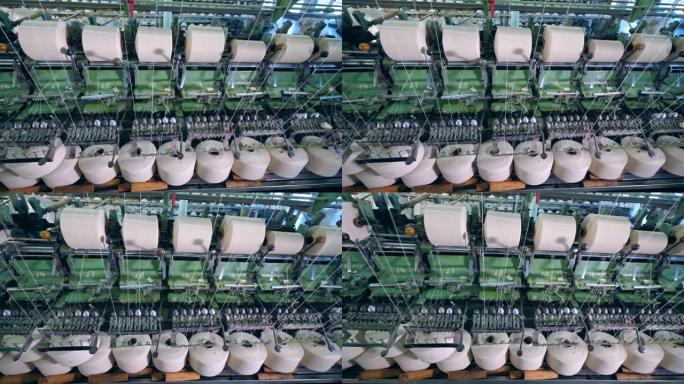 纺织厂用白色纤维卷筒机。纺织织物的织机。