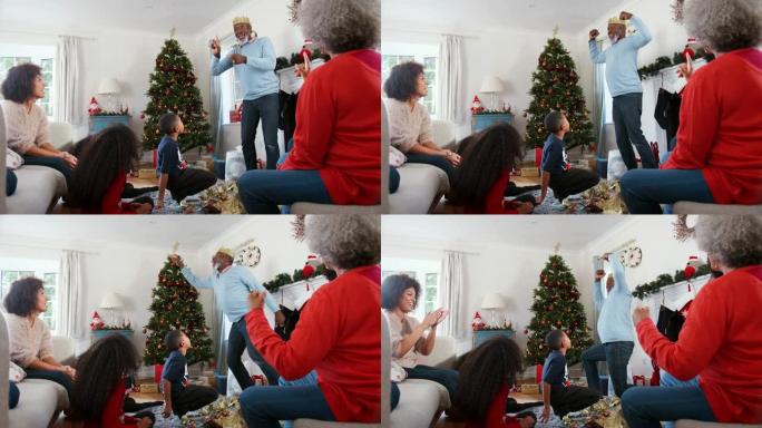多代家庭一起在家庆祝圣诞节时玩猜字谜游戏