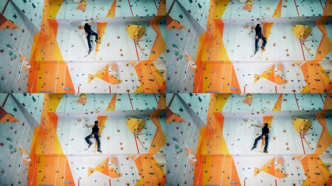一个人在攀岩墙上训练。