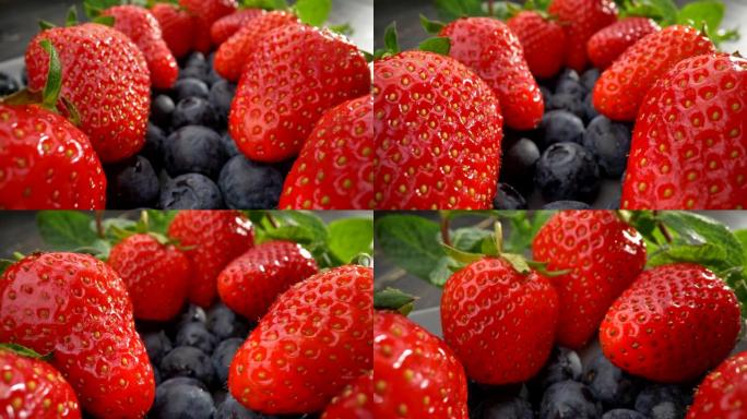 健康饮食。有益蓝莓之上的大红草莓。薄荷留在他们身后。UHD滑块镜头