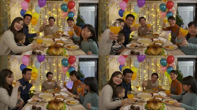 快乐的亚洲家庭打视频电话，在家一起享受圣诞晚餐。