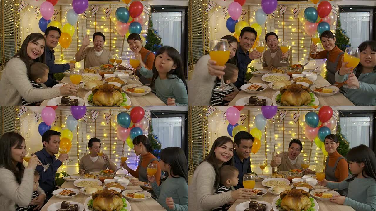 快乐的亚洲家庭打视频电话，在家一起享受圣诞晚餐。