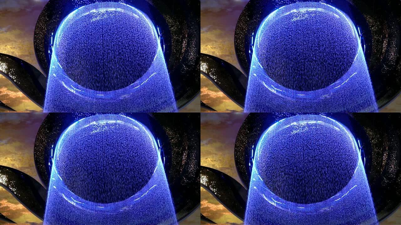 4k慢动作镜头现代水幕，彩色灯光来自天花板、室内喷泉和装饰瀑布概念