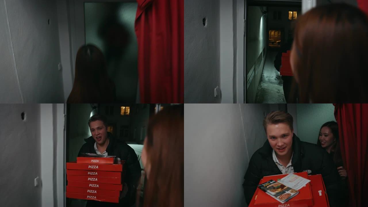 十几岁的女孩用披萨盒欢迎朋友