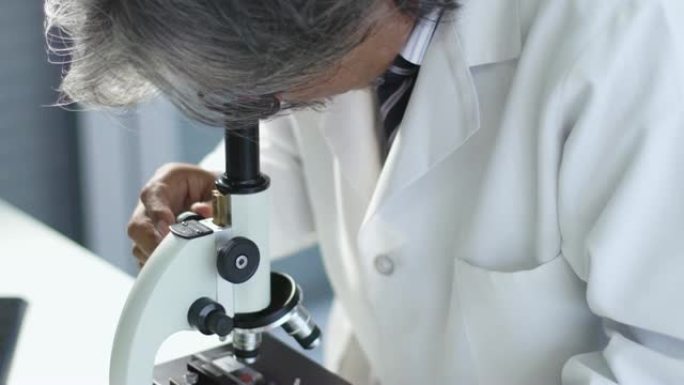 4k: 亚洲科学家在实验室使用显微镜。