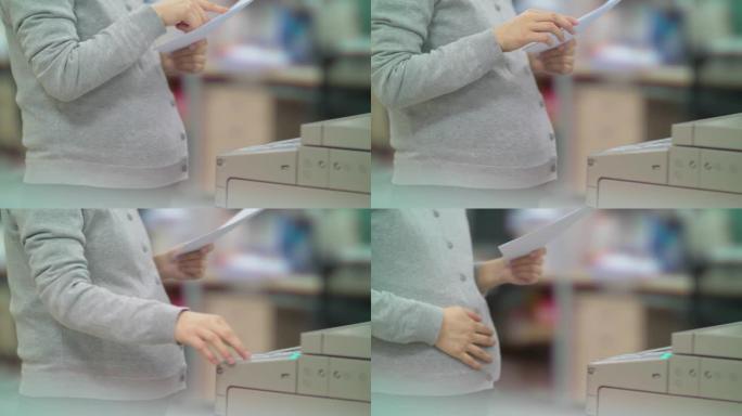 中国孕妇办公室妇女使用复印机