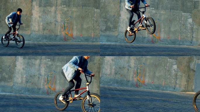 男子在滑板场用自行车做特技，慢动作。