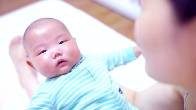 母亲双手抱着新生婴儿