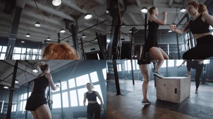 两个年轻漂亮的运动欧洲妇女一起在大型健身房做有氧体育锻炼。动机概念。