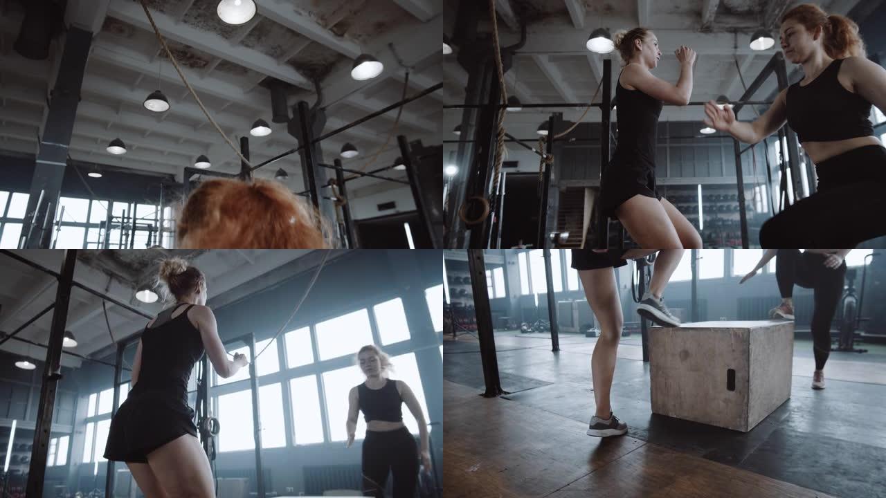 两个年轻漂亮的运动欧洲妇女一起在大型健身房做有氧体育锻炼。动机概念。