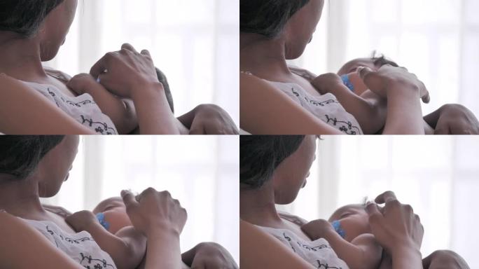 快乐的非洲裔美国母亲，卧室里有新生婴儿。快乐的爱的家庭。家庭关系，新生，人寿保险，生活方式，关系和人