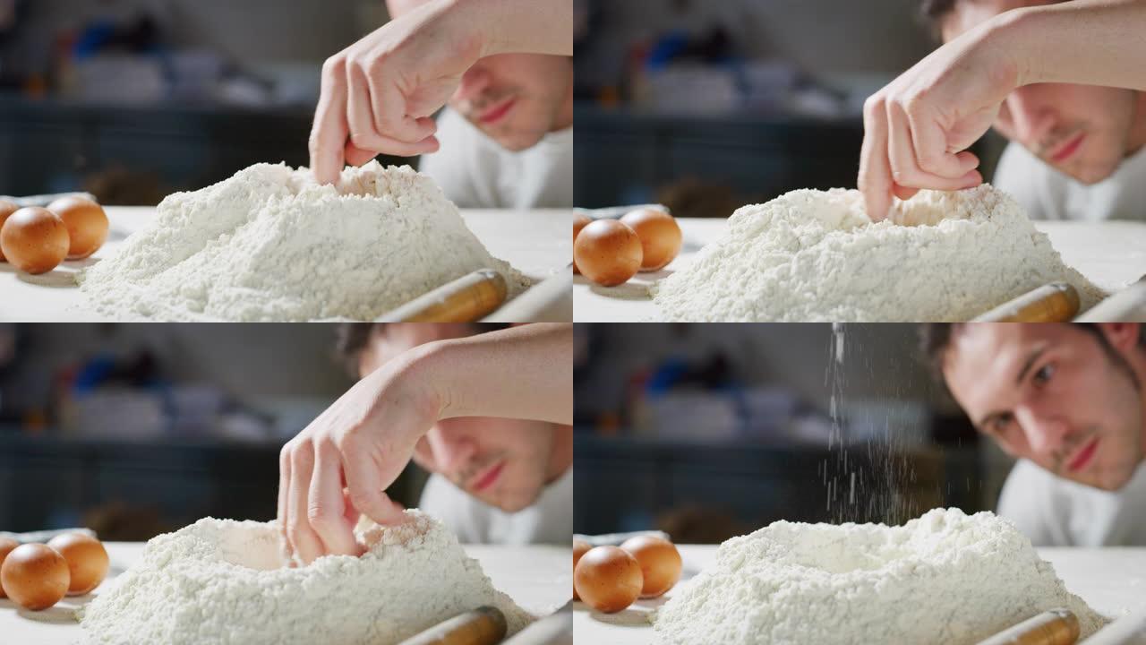 面包师在他的传统木桌上准备面粉，然后用手打一个洞，将鸡蛋扔在里面，制成真正的面团。