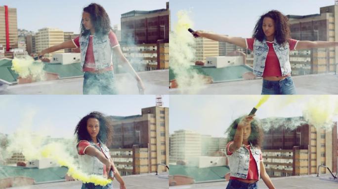 时尚的年轻女子在城市屋顶上使用烟雾弹