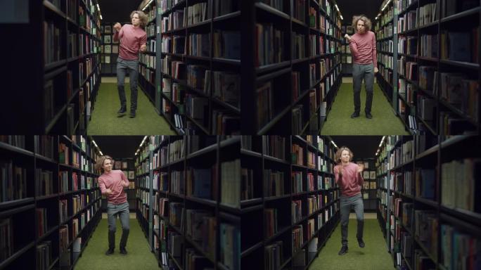 大学图书馆: 英俊的高加索学生庆祝考试成功通过，在成排的书架之间跳舞。大学成功: 入学，毕业，完成硕
