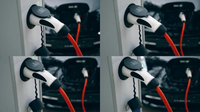 电动汽车充电器插在车站的插座上。创新的电动混合动力汽车充电。