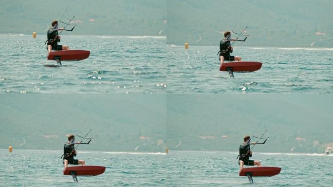 Man女士在克罗地亚Peljesac的阳光明媚的海洋上进行风筝冲浪