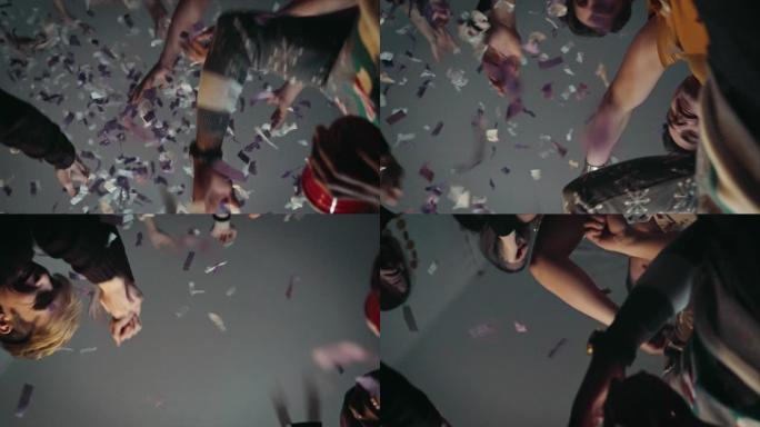 十几岁的朋友在派对上在五彩纸屑中跳舞