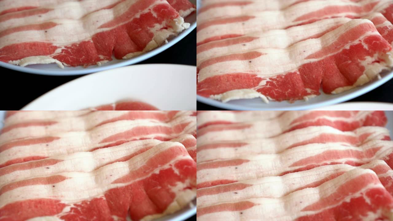 4k慢动作镜头特写，准备盘子里的猪肉培根肉切片，sha锅和Sukiyaki日式食品概念