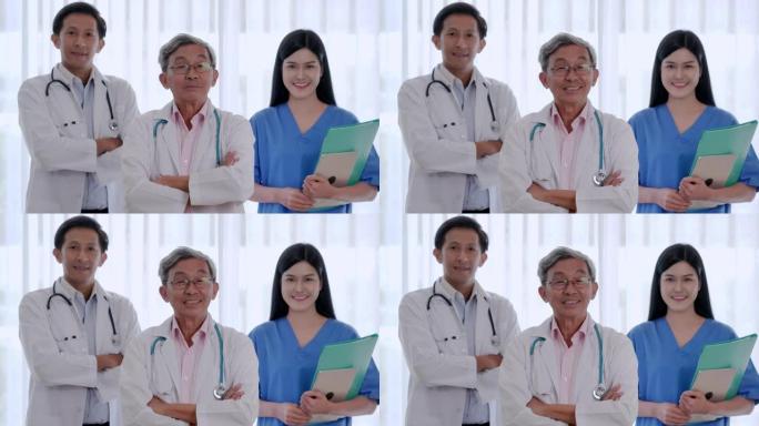微笑自信的医生、护士和助理团队的肖像。专业的医务人员工作。医院里双臂交叉摆姿势的医学家组成的多元化团