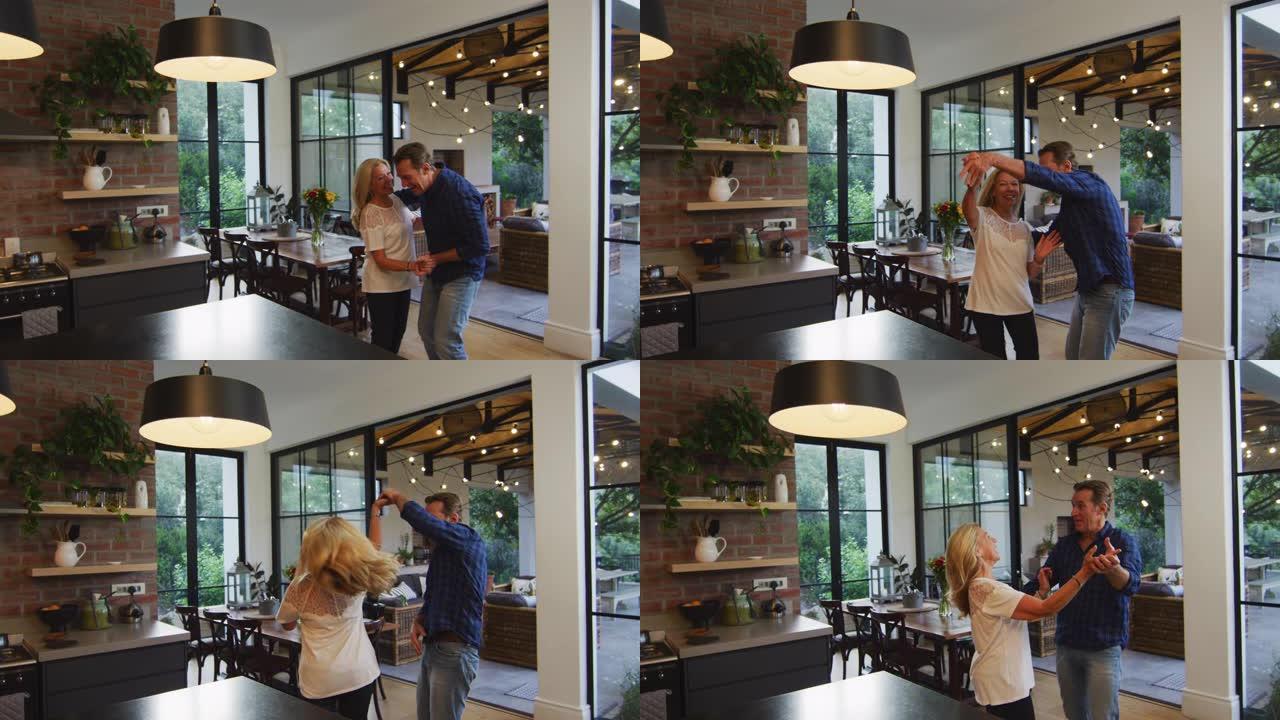 幸福的夫妇在厨房跳舞